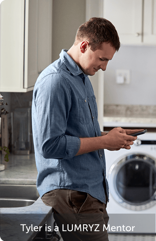 Man using his phone in his laundry room.