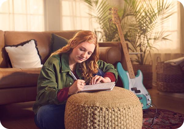 Girl doing homework in her living room