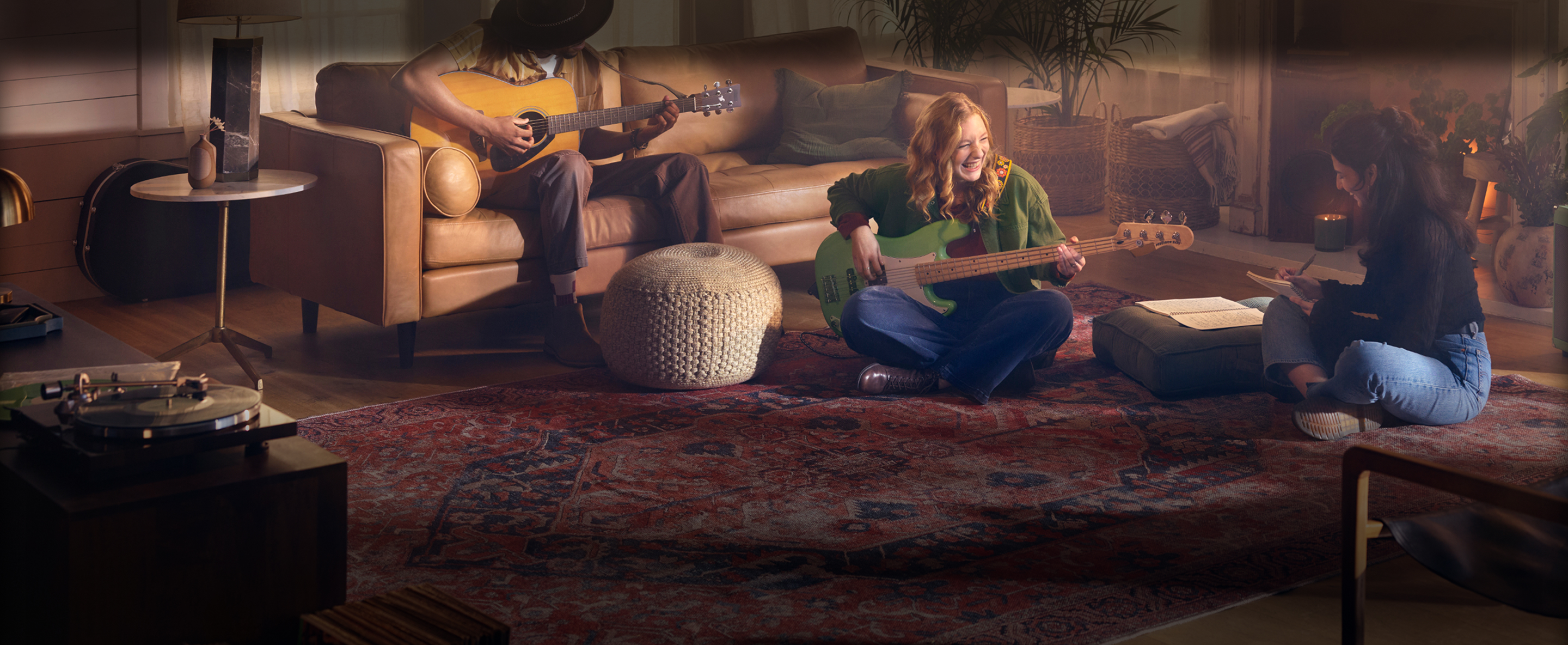 Woman playing guitar in living room with friends